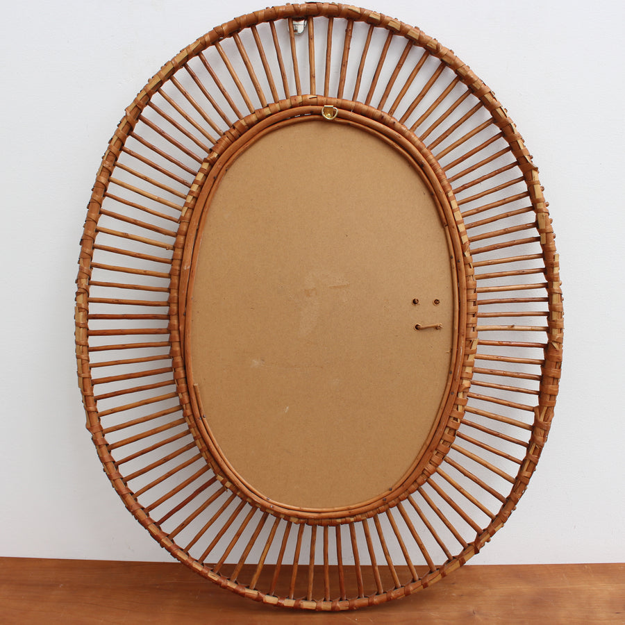 French Rattan Oval-Shaped Wall Mirror (circa 1960s)